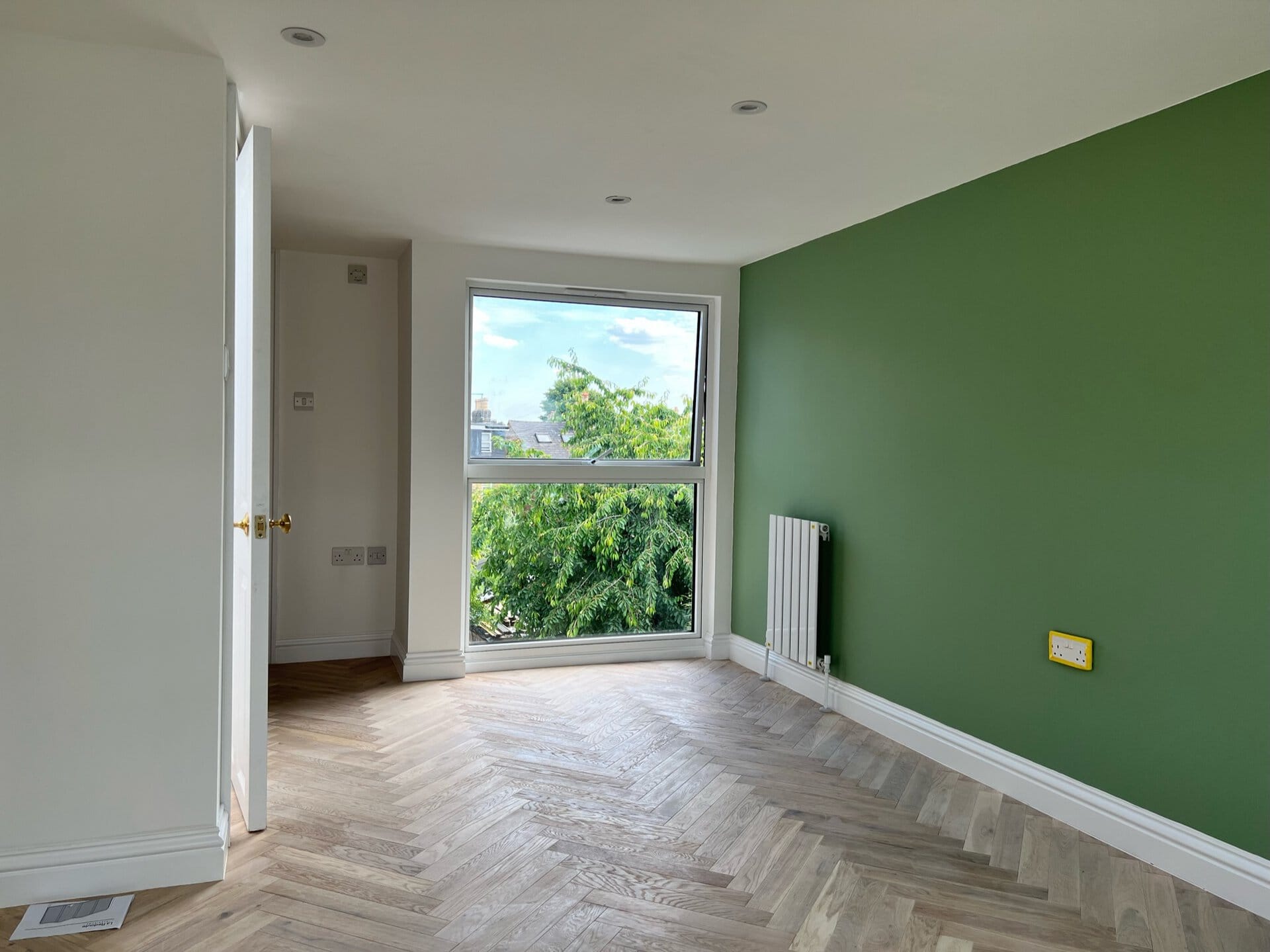 Newly finished room with herringbone flooring